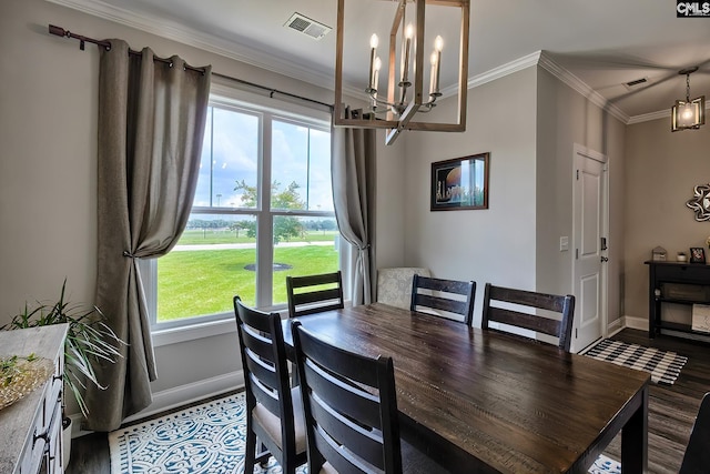 dining area with a notable chandelier, plenty of natural light, crown molding, and hardwood / wood-style floors