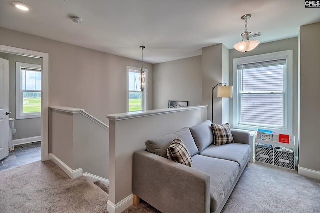 living room with plenty of natural light and carpet