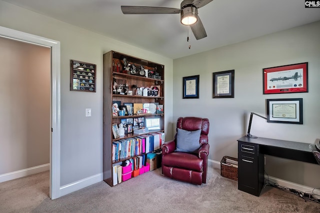 living area with light colored carpet and ceiling fan