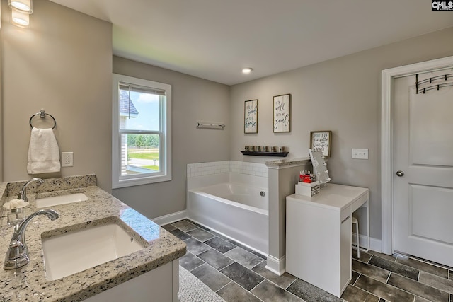 bathroom featuring vanity and a tub