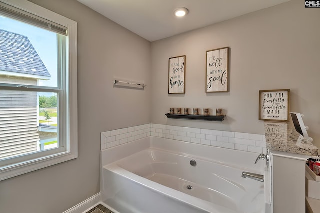 bathroom featuring a bath and plenty of natural light