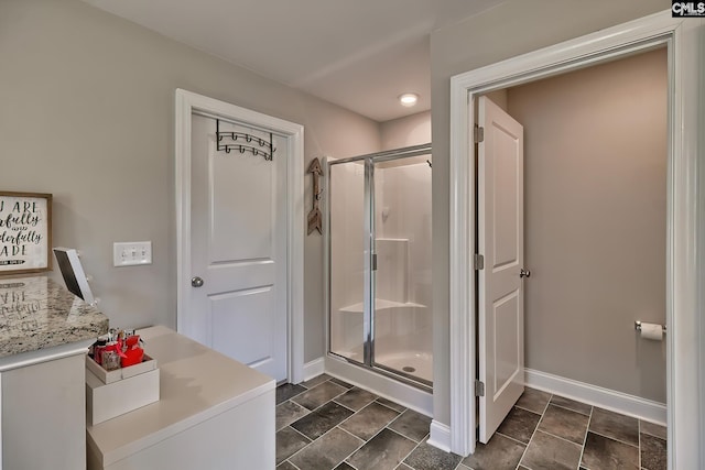 bathroom featuring a shower with shower door