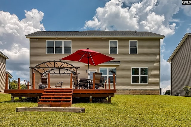 back of property with a yard and a wooden deck