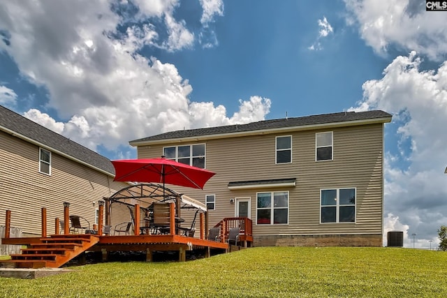 back of property featuring a deck, central AC unit, and a lawn