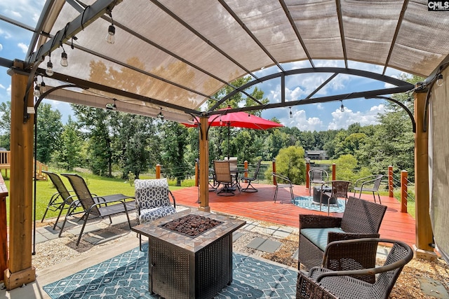 view of patio featuring an outdoor fire pit and a wooden deck