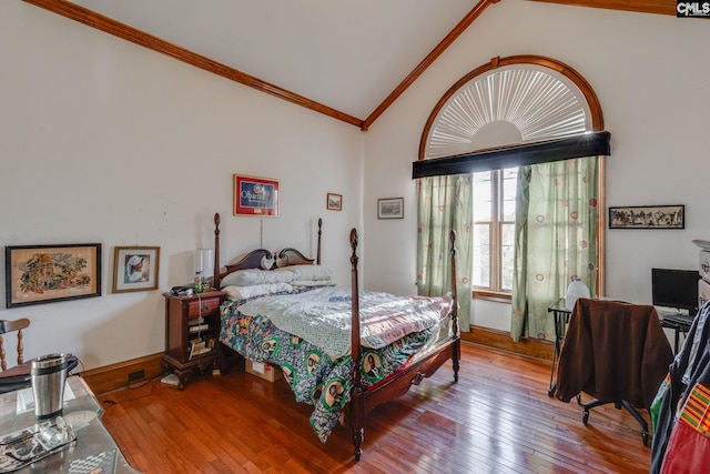 bedroom featuring crown molding, light hardwood / wood-style floors, and vaulted ceiling