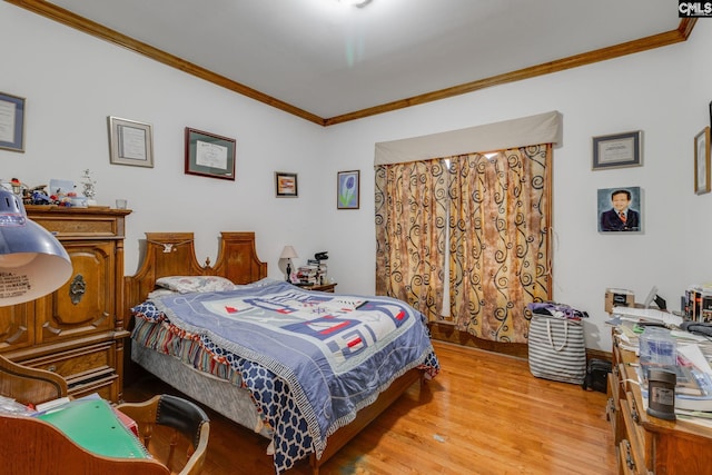 bedroom with light wood-type flooring and crown molding