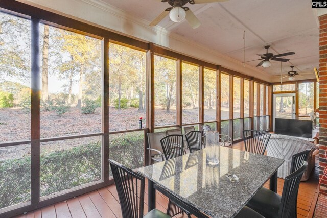 sunroom featuring plenty of natural light and ceiling fan