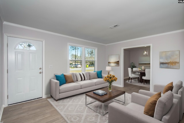 living room with light hardwood / wood-style flooring and ornamental molding