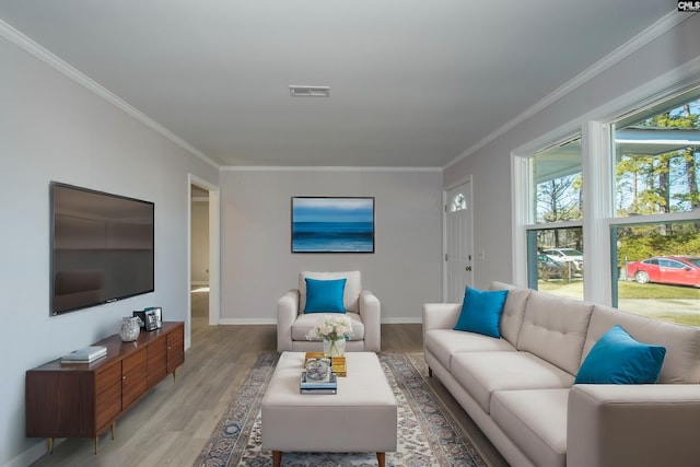 living room with light hardwood / wood-style floors and ornamental molding