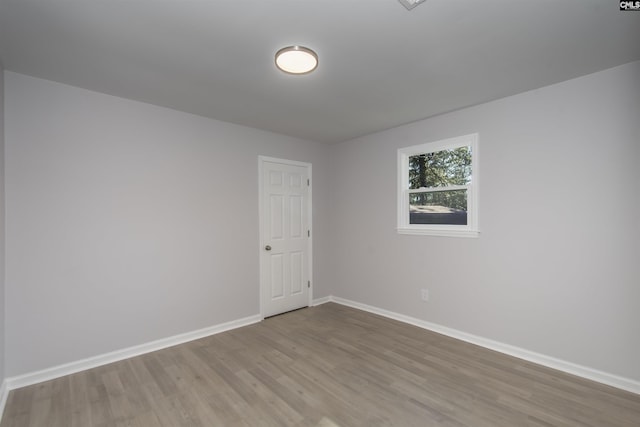 empty room with hardwood / wood-style floors