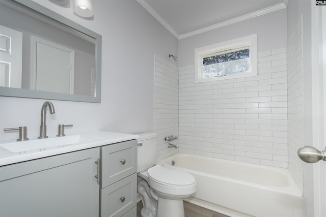 full bathroom with vanity, tiled shower / bath combo, toilet, and ornamental molding