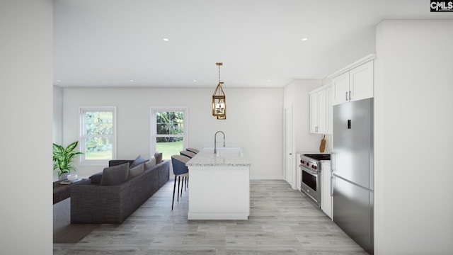 kitchen with light stone countertops, pendant lighting, a kitchen island with sink, white cabinets, and high end appliances