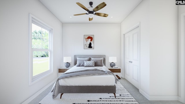 carpeted bedroom with ceiling fan and a closet