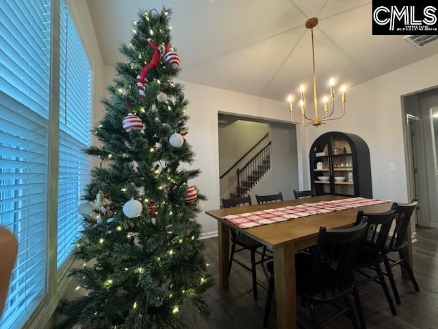 dining room featuring dark hardwood / wood-style flooring and a notable chandelier