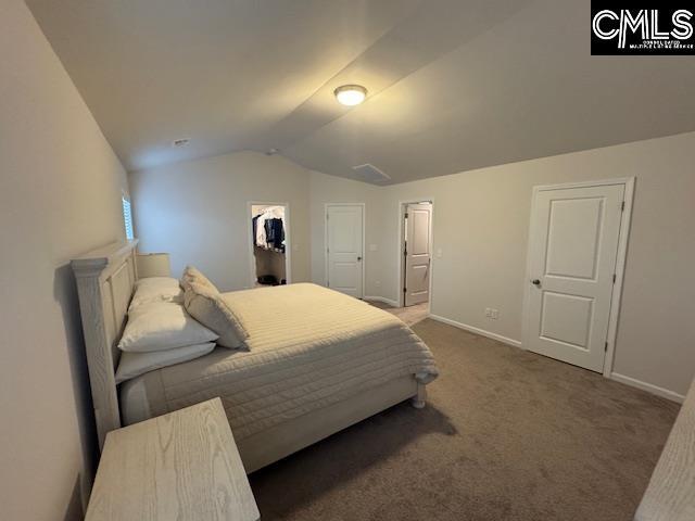 carpeted bedroom featuring lofted ceiling