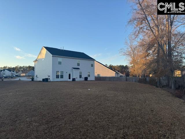 back of property featuring central AC