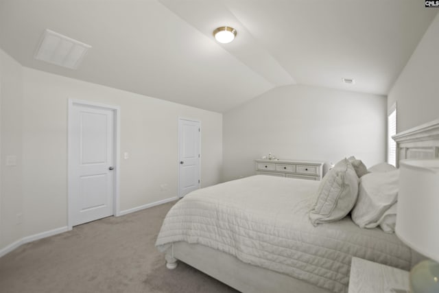 carpeted bedroom featuring lofted ceiling