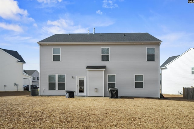 back of house featuring a yard