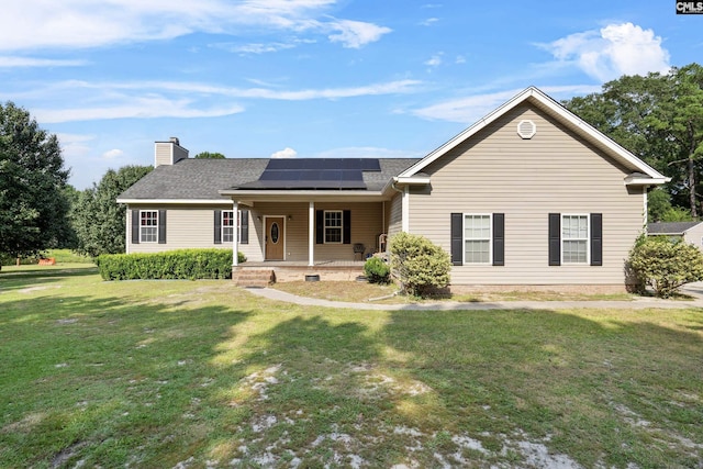 ranch-style house with solar panels, a porch, and a front lawn