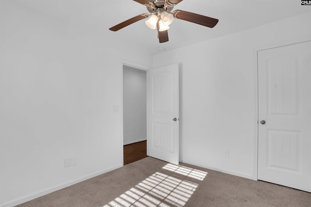 unfurnished bedroom with ceiling fan and carpet floors