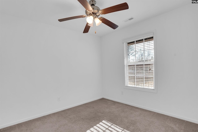 carpeted empty room featuring ceiling fan