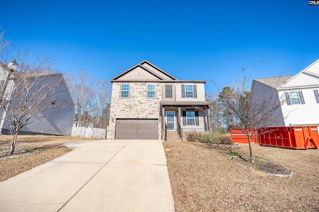 view of front property featuring a porch and a garage