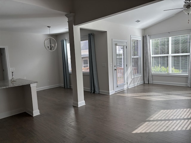 unfurnished living room with ceiling fan with notable chandelier, dark hardwood / wood-style floors, and lofted ceiling