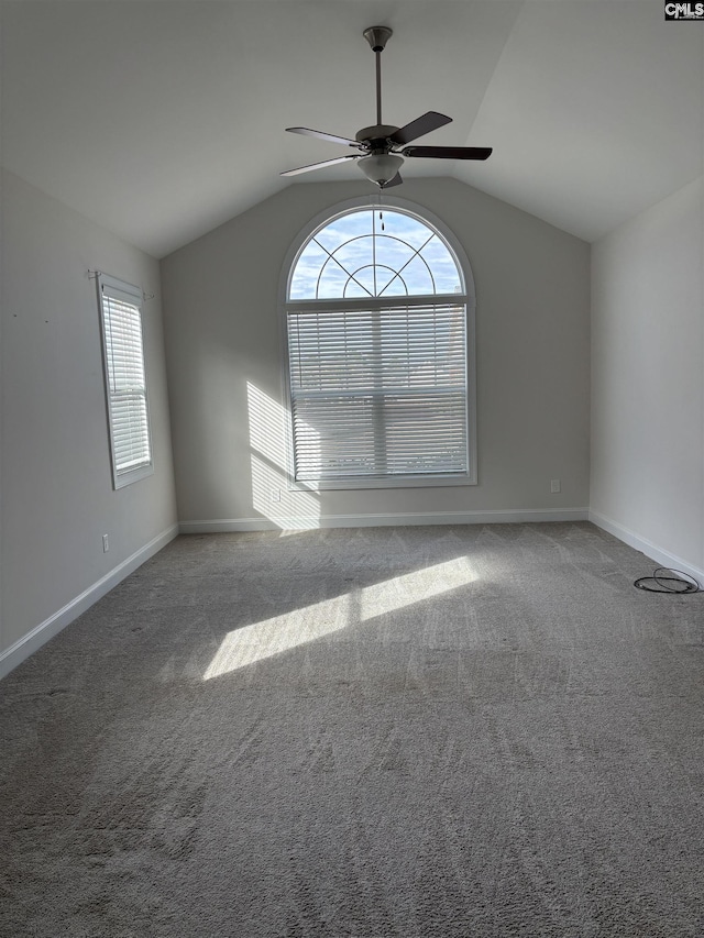 carpeted empty room featuring ceiling fan and lofted ceiling