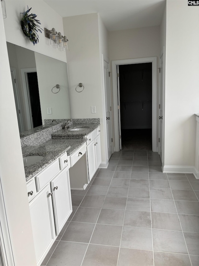 bathroom with tile patterned flooring and vanity