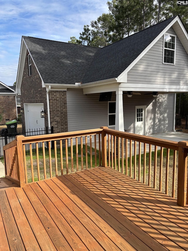 wooden terrace featuring a lawn and area for grilling