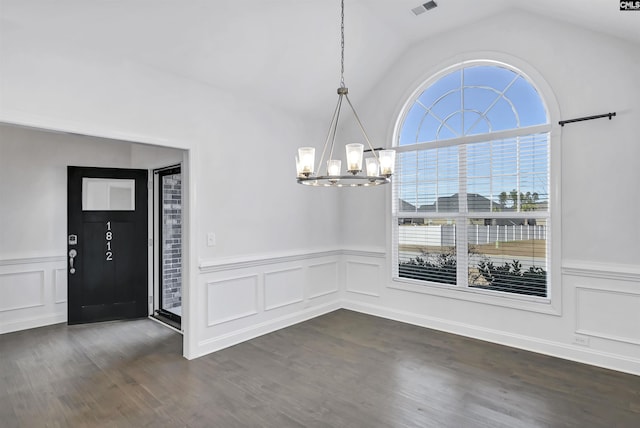 entrance foyer with lofted ceiling, dark wood-type flooring, and an inviting chandelier