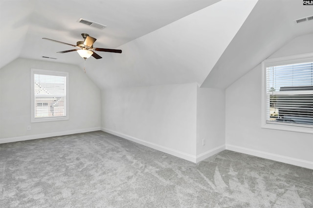 bonus room featuring ceiling fan, light colored carpet, and lofted ceiling