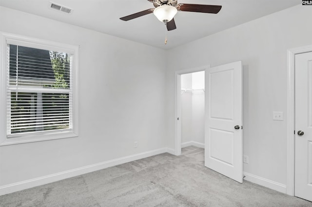 unfurnished bedroom featuring ceiling fan and light carpet