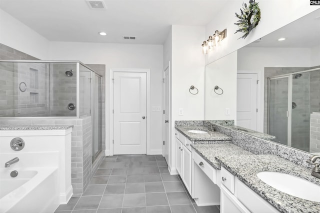 bathroom featuring vanity, tile patterned flooring, and plus walk in shower