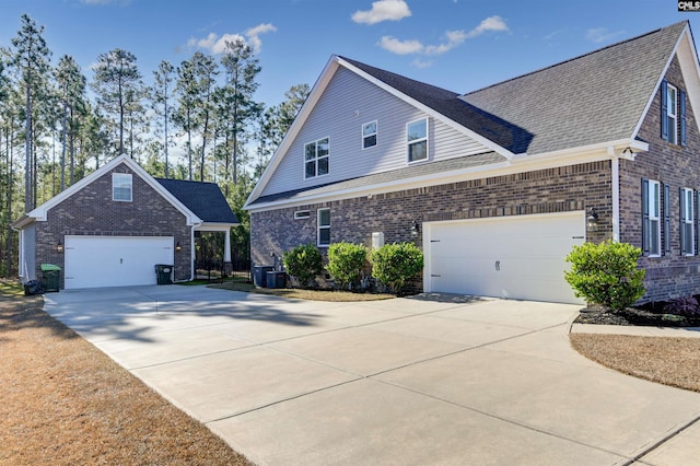 view of front of property with central AC and a garage