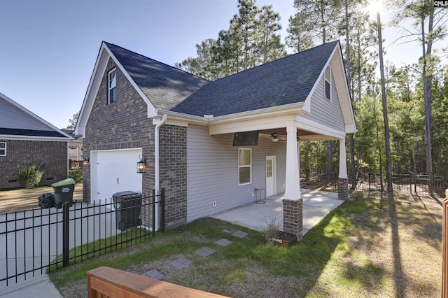 view of side of home with a lawn and ceiling fan