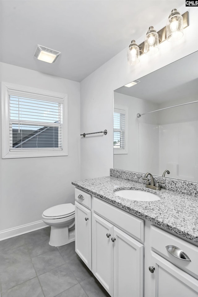 bathroom with walk in shower, vanity, and toilet