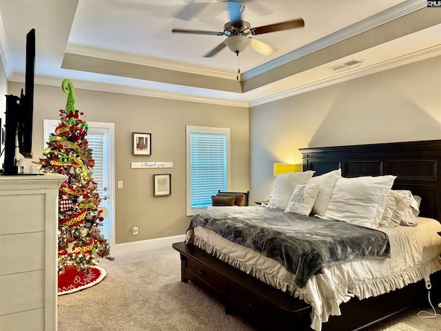 bedroom featuring ceiling fan, light carpet, ornamental molding, and a raised ceiling