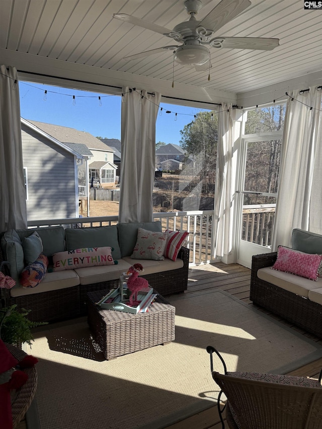 sunroom / solarium featuring ceiling fan