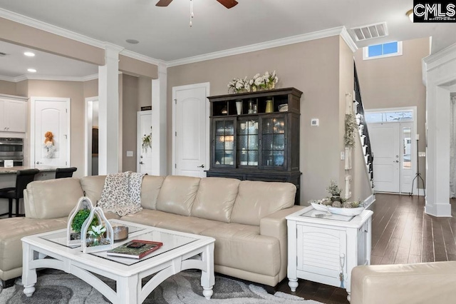 living room featuring ceiling fan, ornamental molding, dark hardwood / wood-style floors, and decorative columns