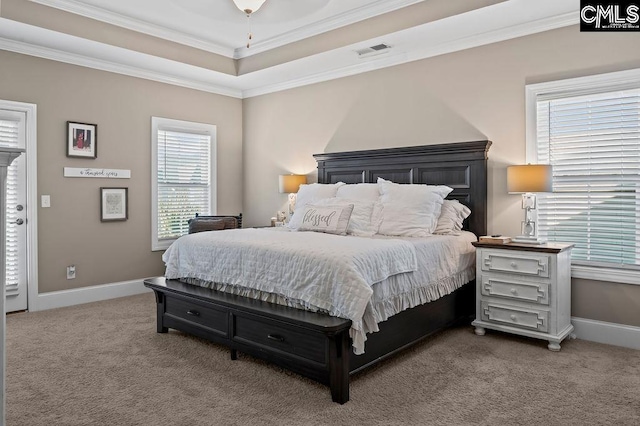 bedroom featuring ceiling fan, carpet flooring, ornamental molding, and a raised ceiling