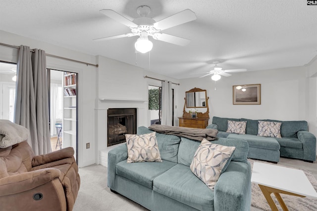 living room featuring a textured ceiling, plenty of natural light, and ceiling fan