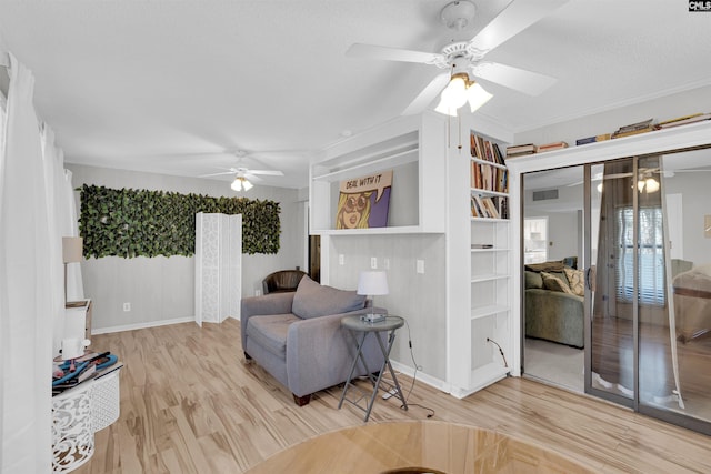 sitting room featuring light hardwood / wood-style floors and ceiling fan