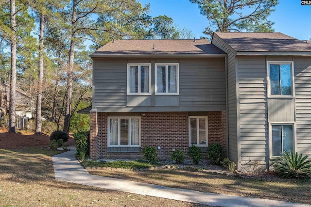 view of property exterior with a lawn