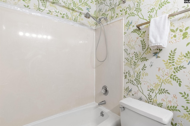 bathroom with washtub / shower combination and toilet