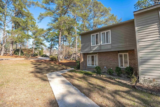 view of side of property with a lawn