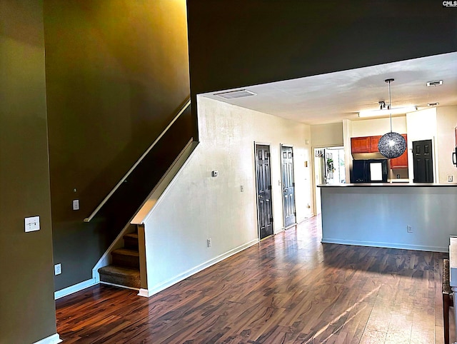 unfurnished living room with dark wood-type flooring