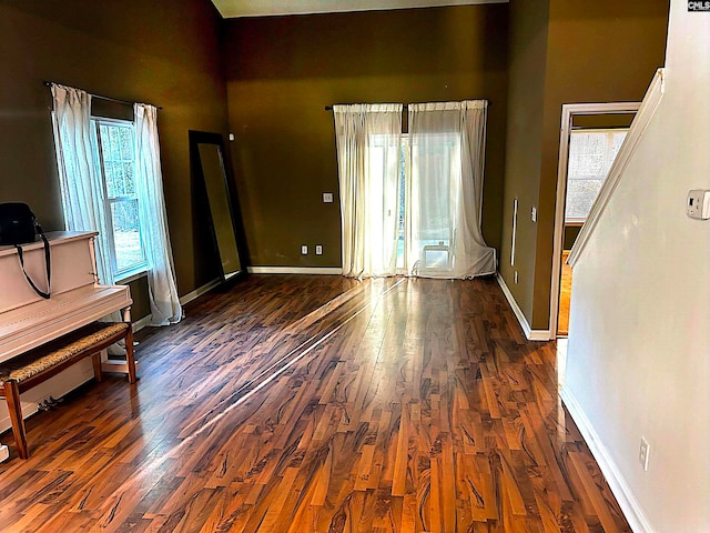 unfurnished living room with dark hardwood / wood-style floors