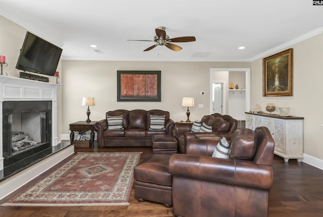 living room with hardwood / wood-style floors, ceiling fan, and ornamental molding